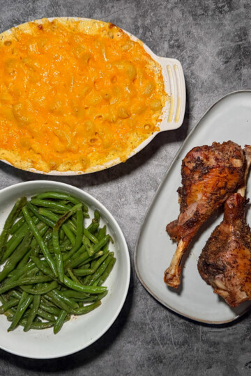 Fuss-free thanksgiving dinner spread with roasted turkey legs, baked mac and cheese, and garlic green beans