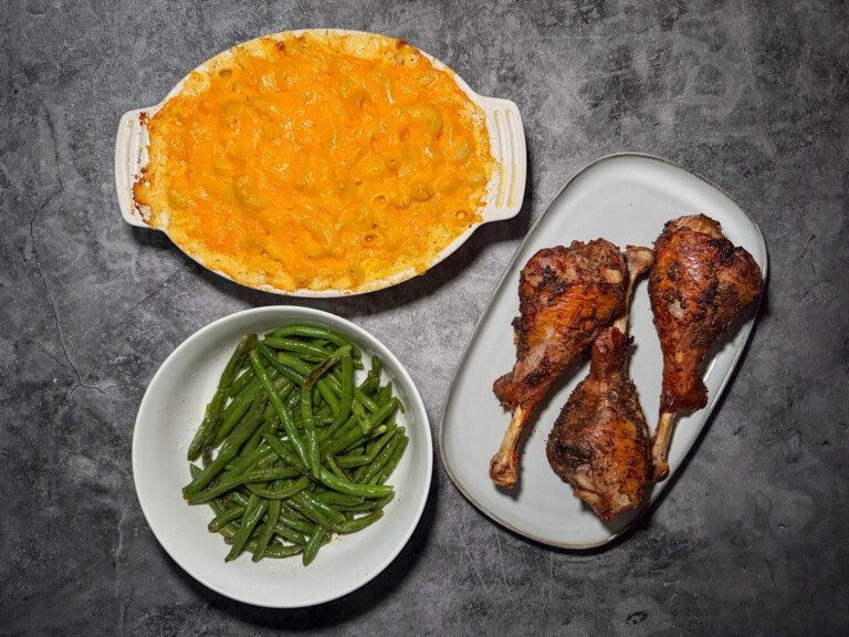 Fuss-free thanksgiving dinner spread with roasted turkey legs, baked mac and cheese, and garlic green beans