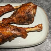 Complete Thanksgiving dinner plate with air fryer turkey drumstick, sides, and dinner roll