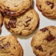 Close-up of chocolate chip cookies showing golden brown edges crispy texture and melted chocolate pools